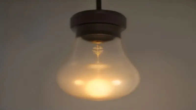 A close-up of a non-illuminated light bulb in a fixture.