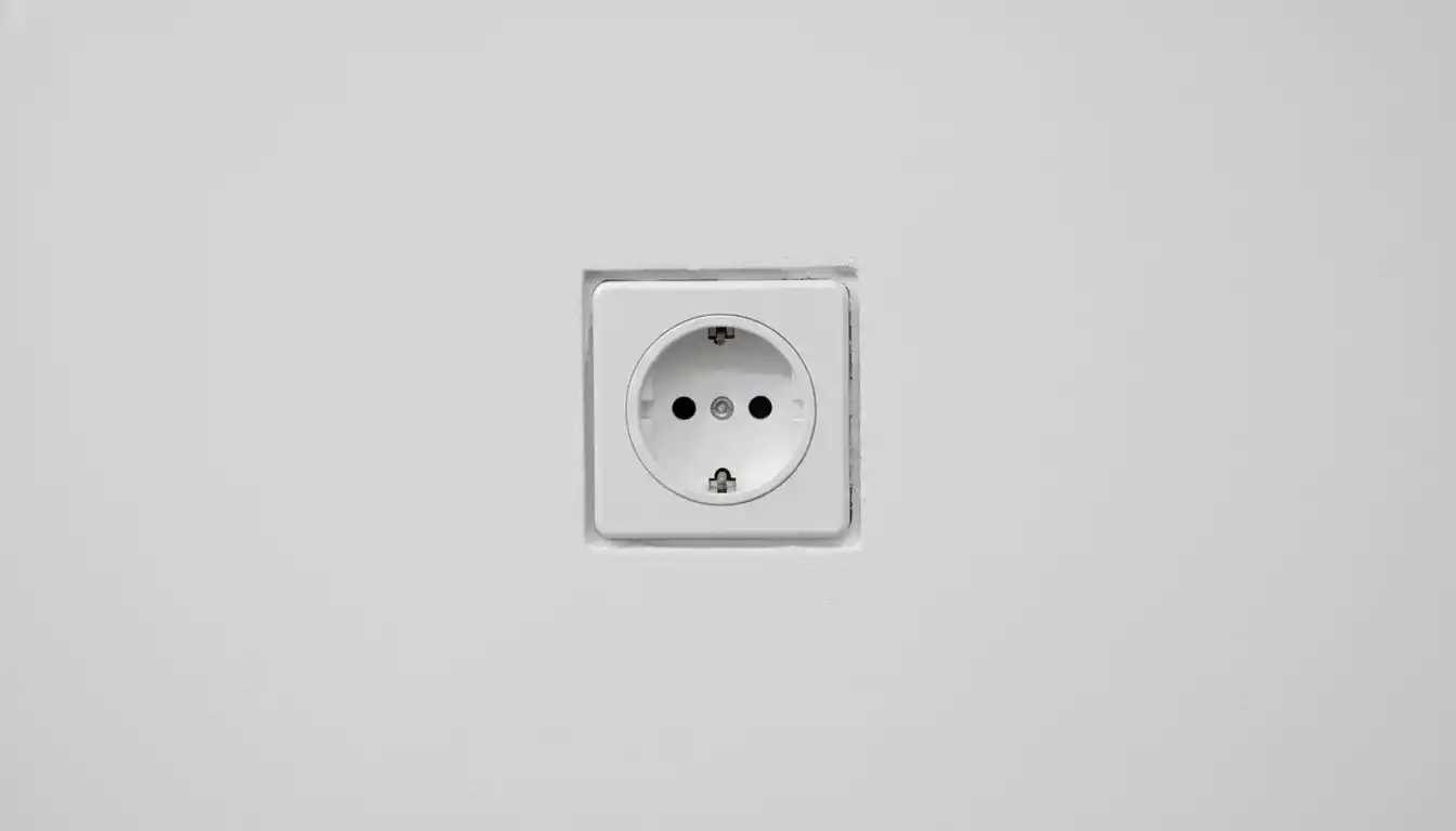 White recessed electrical outlet installed flush in a drywall niche for a stove connection