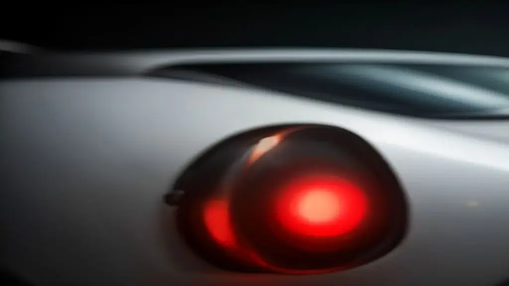 Close up of a car rear end showing a bright central brake lamp while the lower tail lamps remain dark